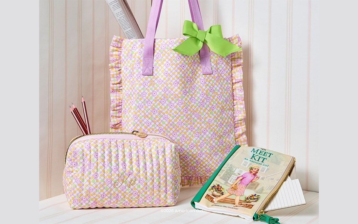 A ruffled Stoney Clover Lane tote and matching pouch in Kit's pastel check print, beside a copy of Meet Kit.