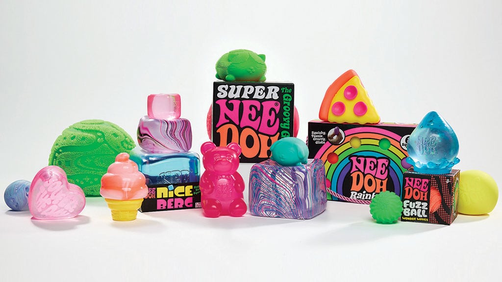 A pile of NeeDoh squishy fidget toys in neon colours, including a gummy bear, a pizza slice and a rainbow.
