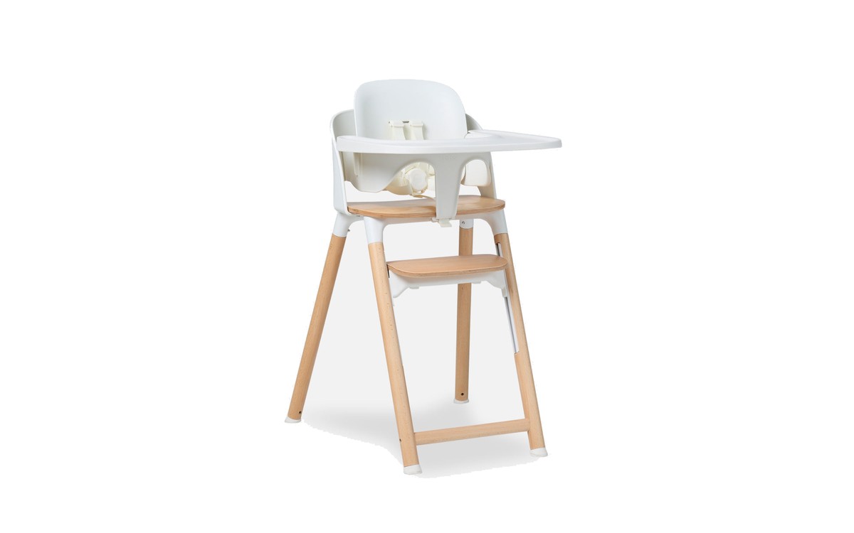 The Lalo Chair II in Coconut, a white high chair on beechwood legs with a white tray and a wooden footrest.