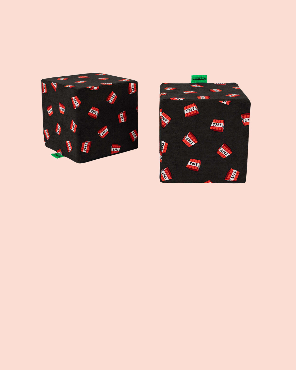 Two Minecraft TNT blocks from Nugget, black cubes printed with red TNT labels, on a pale pink background.