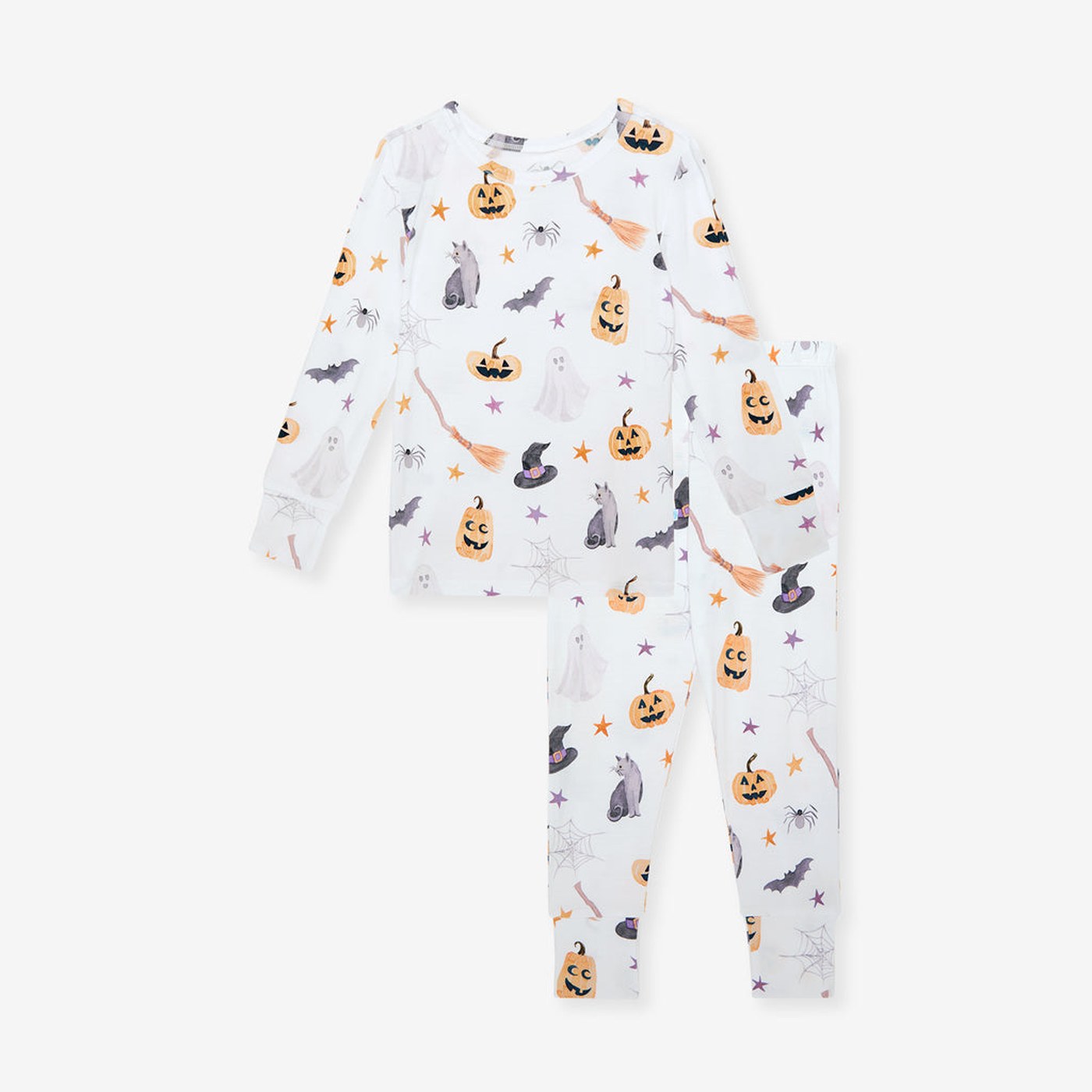 Posh Peanut's Irving classic pajama set, cream with pumpkins, witches' hats and bats, laid flat.