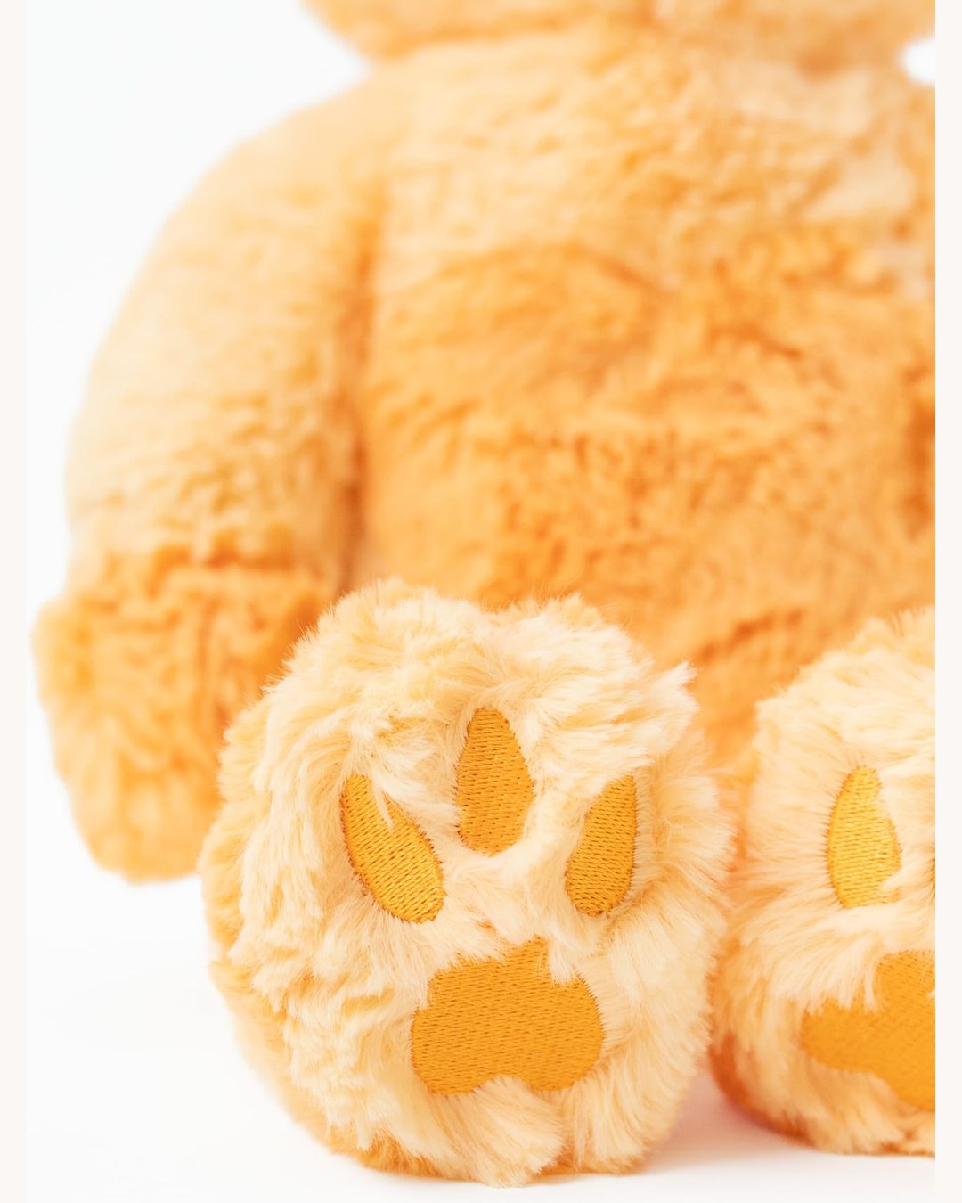 Close-up of the weighted capybara's stitched paw pads.