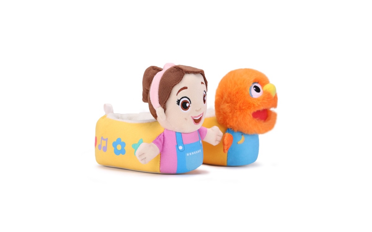The Ms. Rachel and Herbie slippers from Stride Rite: a yellow slipper with a plush Ms. Rachel on the toe and a blue one with a fuzzy orange Herbie.