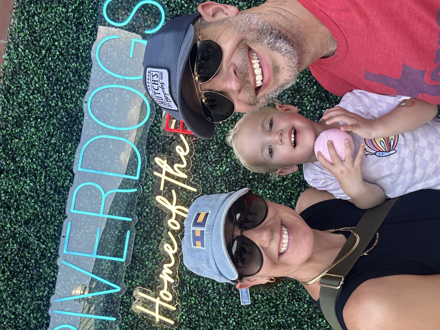 Chris Callahan with his family at a Charleston RiverDogs game, his daughter holding a pink baseball.