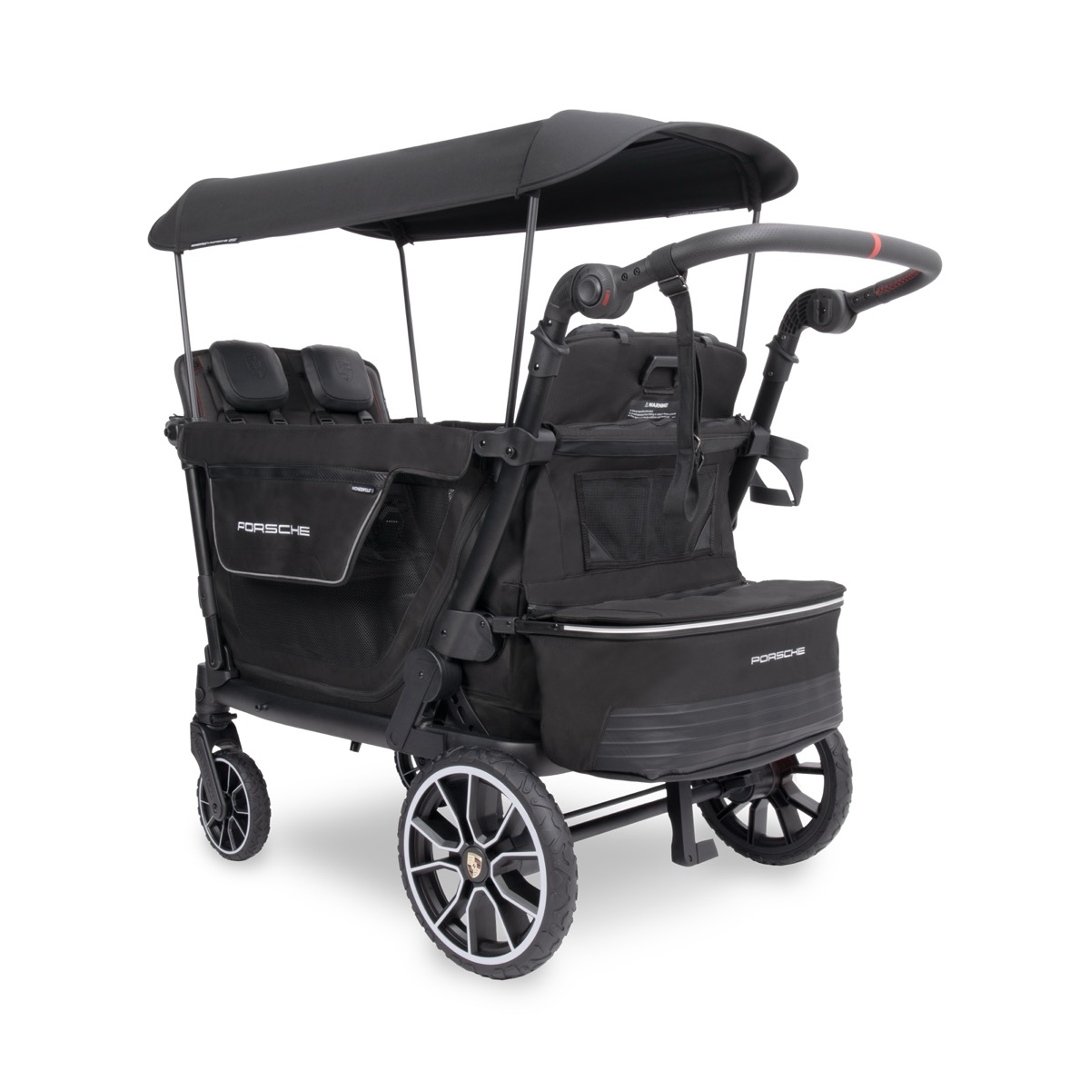 Front three-quarter view of the WonderFold x Porsche wagon showing the red-stitched handlebar and crested rear wheel.