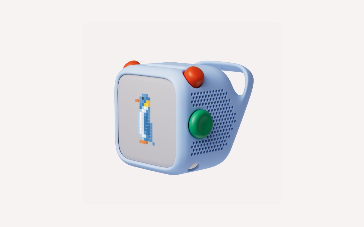 The fourth-generation Yoto Player in a blue Adventure Jacket, showing the new green button on its side.